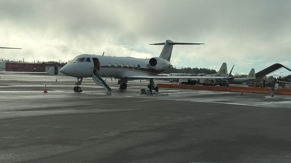 Private jet parked on the ramp alongside other aircraft